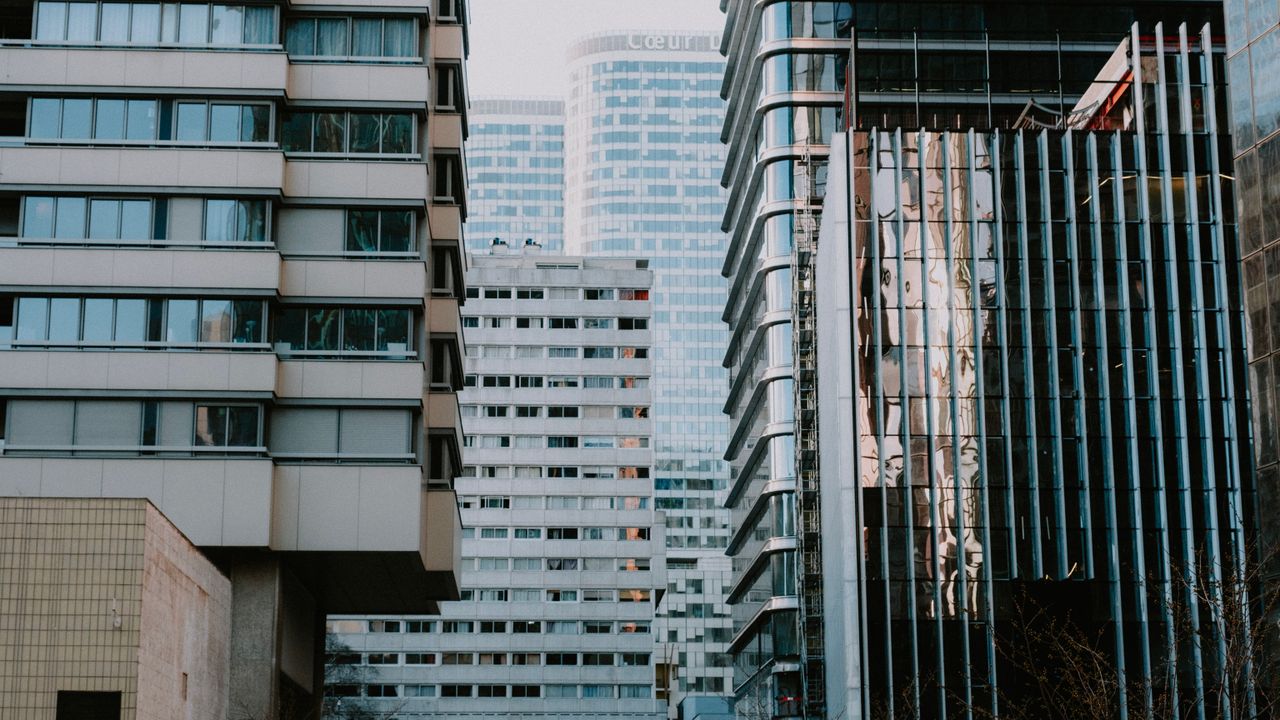 Services A dynamic view of modern high-rise buildings in a city showcasing urban architecture.